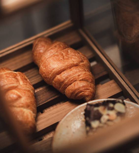 croissant bread dessert bakery in coffee cafe for breakfast, morning fresh meal food background